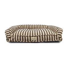 a black and white striped dog bed with a tag on the front, sitting against a white background