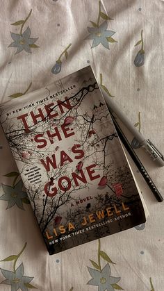 there she was gone by l a jewell book and pen laying on the bed