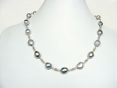 Baroque pearl necklace, silver gray free form pearls, fabulous style for anytime, handmade, Let Loose Jewelry, sterling silver Baroque silver gray pearls for everyday style~ this 19.25 inch necklace can go from jeans and a sweater to an elegant evening look. These pearls are an impressive 10-11mm...just the right amount of substantial, The pearls are linked with Argentium silver onto heavy, flat cable links of sterling silver. The clasp is a user-friendly 13mm and it hooks to a 13mm infinity lin Silver Necklace With Sterling Silver Clasp And Baroque Pearl, Silver Single Strand Baroque Pearl Jewelry, Silver Tahitian Pearl Necklace With Pearl Drop, Silver Tahitian Pearl Jewelry With Pearl Drop, Silver Tahitian Pearl Drop Jewelry, Silver Tahitian Pearl Necklace With High Luster, Silver Single Strand Tahitian Pearl Necklace, Gray Single Strand Pearl Necklace As Gift, Gray Single Strand Jewelry As Gift