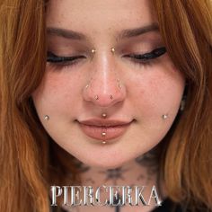 a woman with piercings on her face and nose