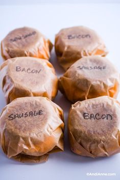 six wrapped sandwiches with the words bacon and sausage written on them