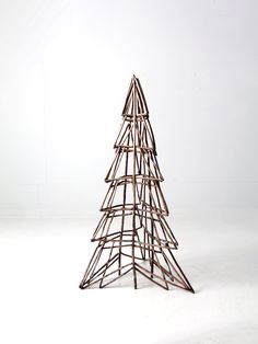 a small wooden christmas tree sitting on top of a white floor