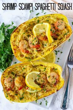 two stuffed spaghetti shells with shrimp and lemons on a white plate next to a fork