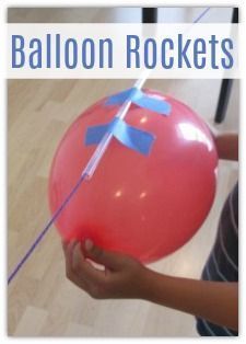 a person holding a red balloon with blue tape on it and a stick sticking out of it