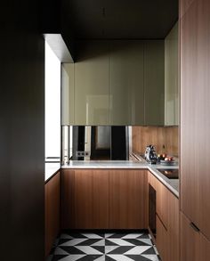 a kitchen with black and white checkered flooring