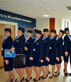 a group of air hostess posing for a photo