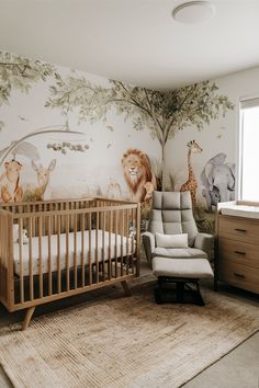 a baby's room with an animal themed wallpaper