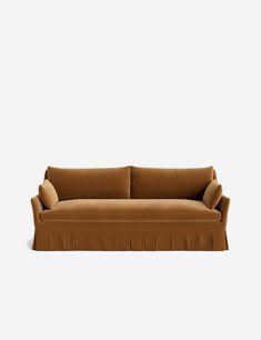 a brown couch sitting on top of a white wall