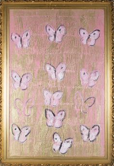 a painting with pink and gold butterflies on it's side in a golden frame