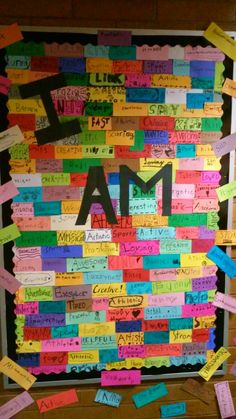 a bulletin board with the word i am written on it and lots of post - it notes