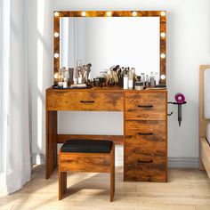 a bedroom with a vanity, mirror and stool