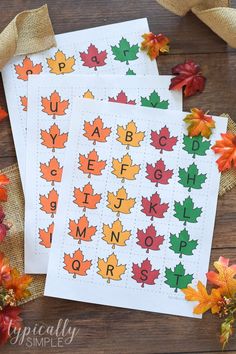 three fall leaves are on top of each other with the letters and numbers in them