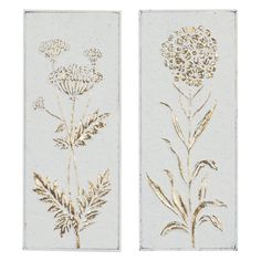 two white and gold wall hangings with flowers on each side, one in the shape of a dandelion