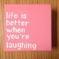 a pink canvas with the words life is better when you're laughing