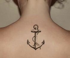 an anchor tattoo on the back of a woman's neck