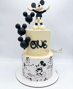 a mickey mouse cake with black and white decorations