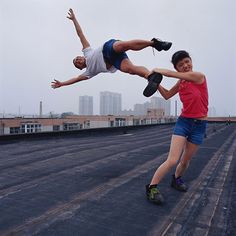 two people are doing tricks on a skateboard