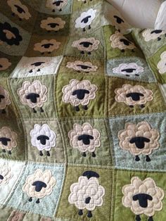 there is a quilt with sheeps on it