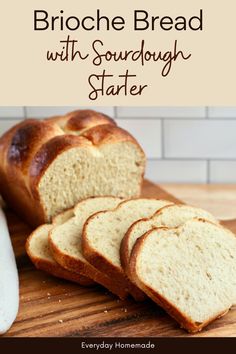 a loaf of bread sitting on top of a wooden cutting board next to sliced bread