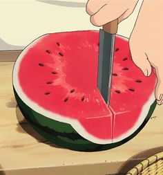 someone cutting into a piece of watermelon with a knife