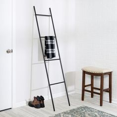 a ladder leaning up against a white wall