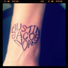 a small tattoo on the ankle that says austin jacob doar in black ink