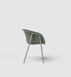 a green chair sitting on top of a white floor