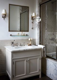 a bathroom with two sinks and a shower