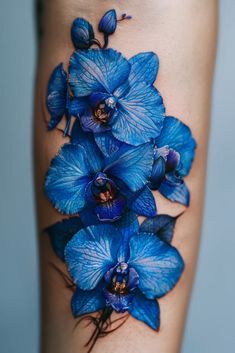 blue flowers on the side of a woman's leg