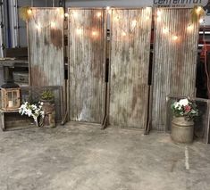 three wooden partitions with lights on them in an industrial warehouse or workshop, set up for display