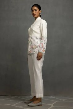 White top in linen base with floral and tabla instrumental embroidery in thread, sequins and beads. Paired with a pant. - Aza Fashions Spring Festive Sets With Pearl Embroidery, Elegant Cotton Palazzo Set With Intricate Embroidery, Elegant Cotton Palazzo Set For Spring, Elegant Spring Cotton Palazzo Set, Elegant Embroidered Cotton Palazzo Set, Elegant Linen Set With Resham Embroidery, Fitted Palazzo Set With Intricate Embroidery For Spring, Spring Fitted Palazzo Set With Intricate Embroidery, White Linen Festive Sets