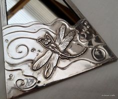 a decorative mirror with a dragonfly on it