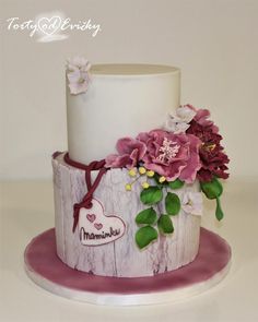 a white and pink cake with flowers on it