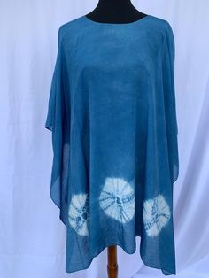 This gorgeous silk/cotton blend poncho is hand-dyed using a traditional Japanese Shibori technique to create a stunning design resembling a sand dollar!  It is a lovely blue color, with an off-white design.  Truly a unique, beautiful and versatile accessory! Japanese Shibori, Shibori Techniques, Shibori Silk, Ladies Poncho, Sand Dollar, Traditional Japanese, White Design, Shibori, Japanese Traditional