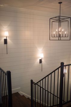 the lights are on above the railing in the house's entryway, which is painted white