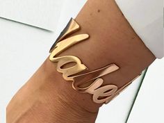 ✨ Express Yourself with this stunning Personalized Name Women's Bangle, crafted from high-quality stainless steel. This chic bracelet is perfect for adding a touch of individuality to your style, whether you're dressing up for a special occasion or adding flair to your everyday look. Available in gold, silver, rose gold, and black, this bangle is designed to complement any outfit. 💖 Features: Material: Durable Stainless Steel with high-quality plating Color Options: Gold, Silver, Rose Gold, Bla Elegant Metal Bracelet With Custom Name, Elegant Custom Name Metal Bracelet, Rose Gold Metal Cuff Bracelet As Gift, Personalized Rose Gold Bracelets For Party, Personalized Rose Gold Bracelet For Party, Modern Rose Gold Cuff Bracelet For Party, Modern Rose Gold Party Cuff Bracelet, Womens Bangles, Punk Inspiration