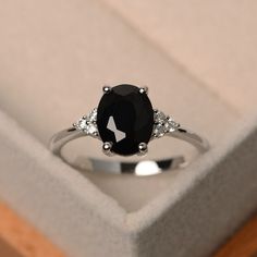 a black and white diamond ring in a box