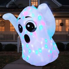 an inflatable ghost with lights on it's face and eyes is outside at night