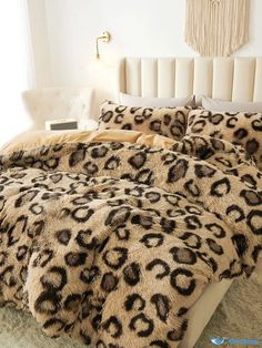 a leopard print comforter set on a bed