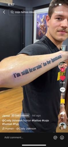 a man with a tattoo on his arm that says i'm still learning to be human