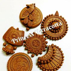 four wooden buttons with designs on them