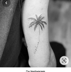 a small palm tree tattoo on the arm