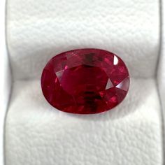 an oval shaped red diamond in a white box