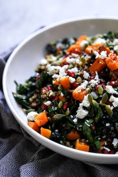 a white bowl filled with vegetables and feta cheese