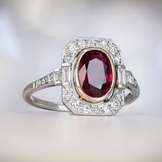 A magnificent gemstone ring featuring an oval cut ruby set in the center of an 18k yellow gold bezel, with a weight of approx 1.66 carats. The center stone is surrounded by old mine-cut diamonds with a total weight of approx. 0.50 carats that are set in a halo, this handcrafted platinum ring. ✦ GEMSTONE SPECIFICATIONS: Center Gemstone: Ruby Diamond Cut: Oval Cut and Old Mine Cut Ring Center Gemstone Weight: Approx 1.66 Carats ✦ ENGAGEMENT RING SPECIFICATIONS: Total Diamond Weight: Approx 0.50 Ca Vintage Oval Ruby Ring With Bezel Setting, Luxury Oval Ruby Ring In Art Deco Style, Gold Ruby Ring With Bezel Setting, Oval Cabochon, Oval Ruby Ring In 14k Gold, Art Deco Style, Peacock Sapphire, Classic Red Ruby Ring, Oval Cabochon, Estate Diamond Jewelry, Ruby Set, Feminine Fashion