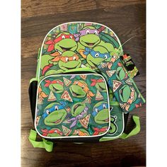 two backpacks with teenage turtles on them sitting next to each other in front of a wooden table