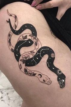 a woman's thigh with a snake tattoo on it