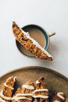 a plate topped with cookies next to a cup of coffee