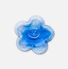 a blue flower shaped object sitting on top of a white table