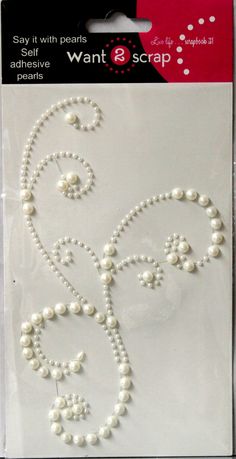 a package of white pearls with swirls and beads on the back of it's packaging